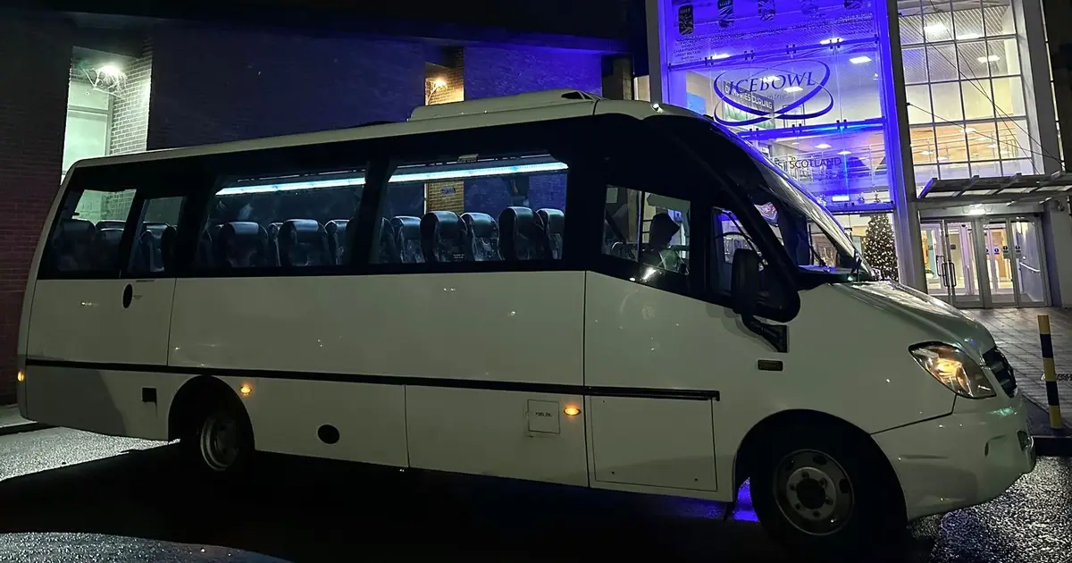 A 25 seater Mercedes Sprinter midibus parked at night in Telford
