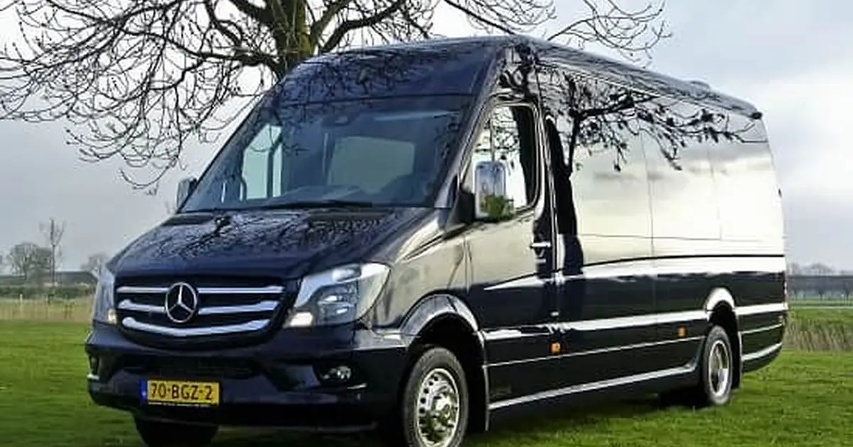A 16 seater Mercedes Sprinter minibus parked on a field in Tilburg