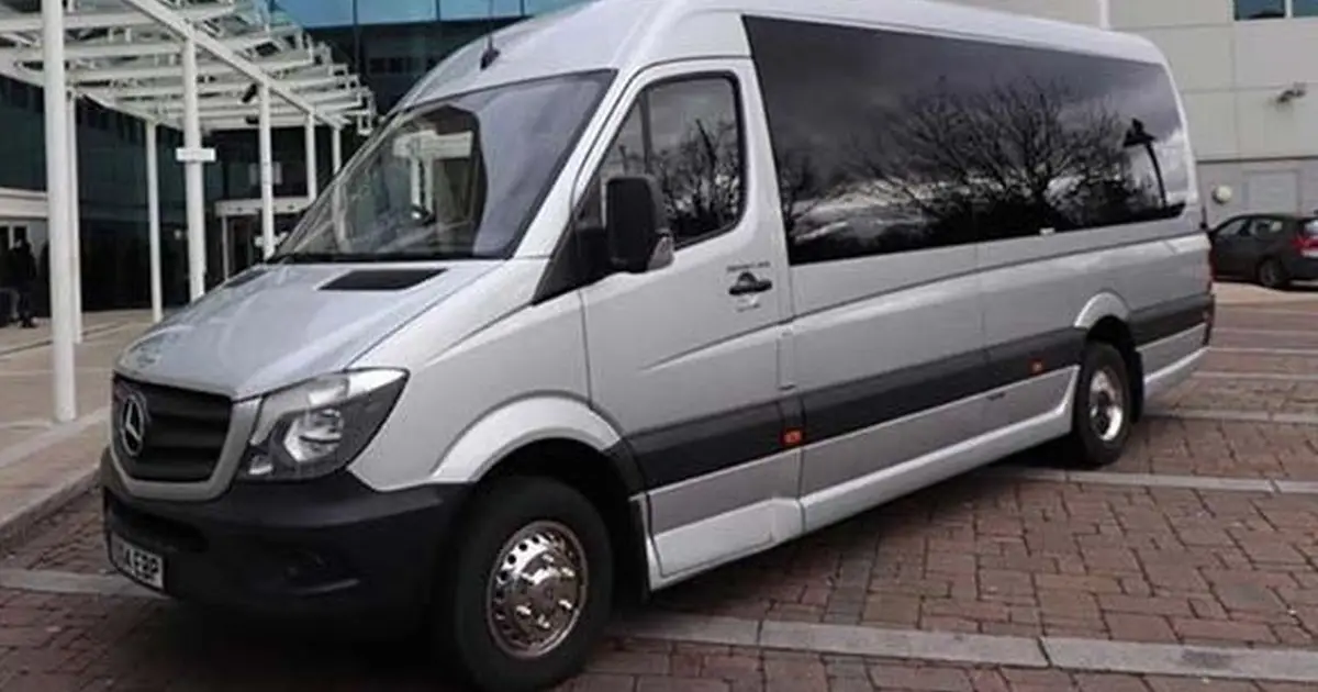 A 22 seater midibus Mercedes Sprinter at a parking in London