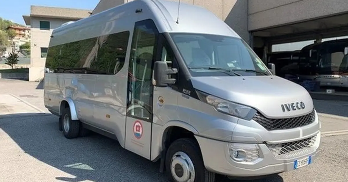A 19 seater minibus Iveco Sprinter parked in Bergamo